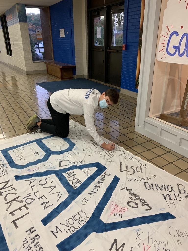 Michael Muccio signs the XC state banner.